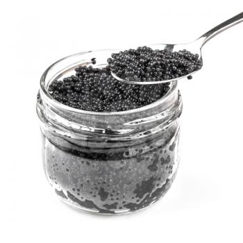 Black caviar in a glass jar with spoon isolated on white