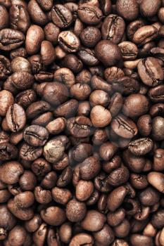 Closeup vertical photo background with dark roasted coffee beans