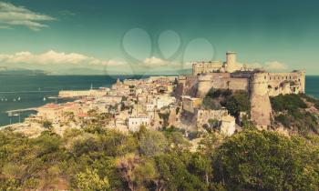 Landscape of old town Gaeta with ancient castle on coastal rock, Italy. Vintage warm tonal correction photo filter, old style effect