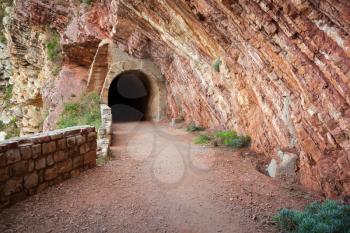 Dark old tunnel entrance in red rock