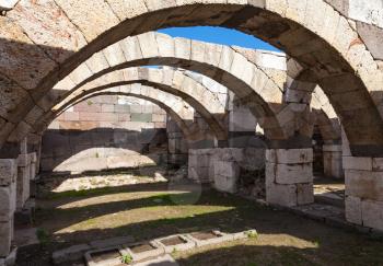 Empty stone corridor with arches. Ruins of Ancient city Smyrna. Izmir, Turkey