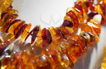 Macro photo of orange amber beads on white background