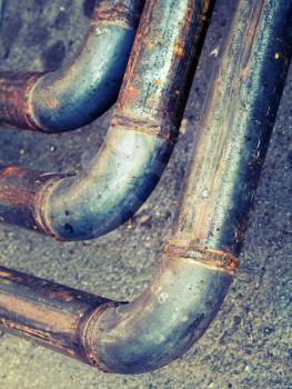 Bend of industrial steel pipeline, vintage toned photo