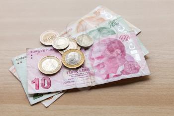 Different banknotes and coins. Turkish money with Ataturk portrait on wooden table background