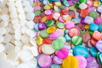 Beads of round colorful stones lie on the counter of souvenir shop on the beach in Dominican republic