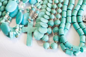 Beads of blue turquoise stone lie on the counter of souvenir shop on the beach in Dominican republic