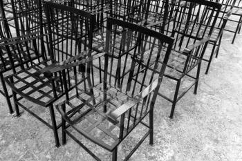 Vintage black metal chairs stand in a row
