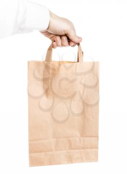 Modern shopping paper bag in male hand isolated on white