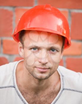 Closeup portrait of young slightly smiling construction worker