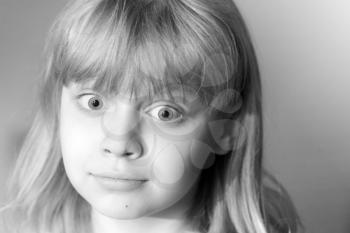 Monochrome portrait of confused little blond girl