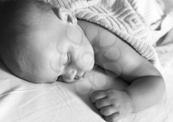 Monochrome portrait of Little baby sleeping in the bed under soft blanket