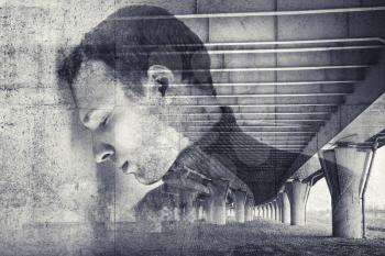 Double exposure abstract conceptual photo collage, sad stressed young man with concrete wall and industrial urban background