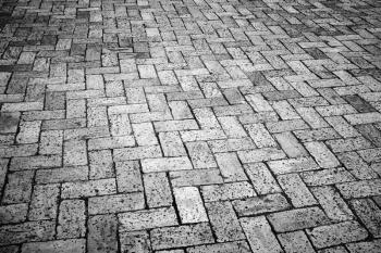 Old dark gray cobblestone pavement, background photo with perspective effect
