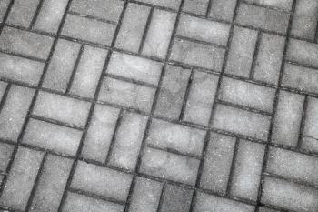 Old dark gray wet cobblestone pavement, background photo texture