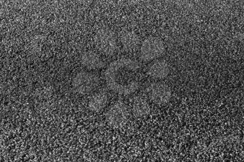 New black asphalt pavement immediately after asphalting, background with selective focus on the middle of the road