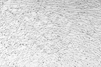 Broken glass with cracks pattern, monochrome background texture