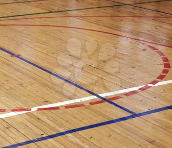Wooden floor of sports hall with colorful marking lines
