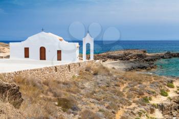Coastal landscape of Agios Nikolaos. White Orthodox church on the Ionic Sea coast. Zakynthos island, Greece