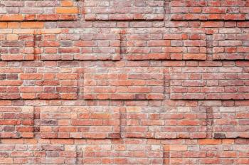 Red brick wall with decorative rectanglular relief pattern, background photo texture