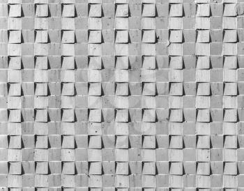 Gray concrete wall with abstract square relief pattern, front view, background photo texture