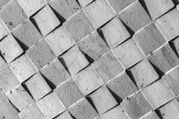 Gray concrete wall with abstract square relief pattern, closeup background photo texture