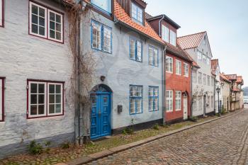 Street prspective with traditional colorful living houses along the street in old Flensburg, Germany