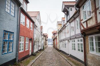 Street prspective with traditional colorful living houses along the street in old town of Flensburg city, Germany
