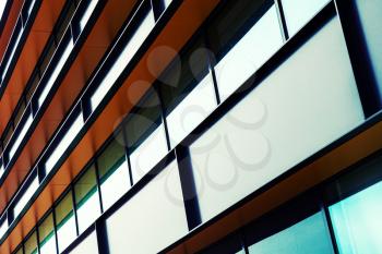 Modern industrial building facade, colorful abstract fragment, shiny windows in steel structure. Colorful tonal filter effect