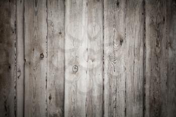 Uncolored old grungy wooden wall, frontal flat background photo texture with vignette effect
