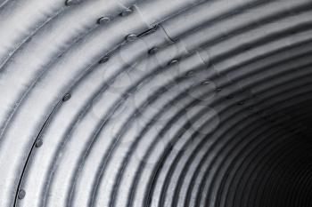 Abstract steel tunnel interior fragment, corrugated arch pattern