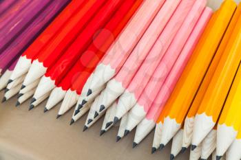 Stack of colorful graphite pencils, closeup photo with selective focus
