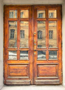 Old weathered wooden door with distorted reflection