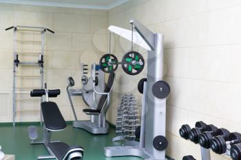 Fitness club gym with sport equipment modern interior