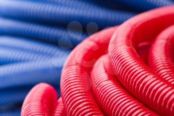 Rolls of red and blue pipes