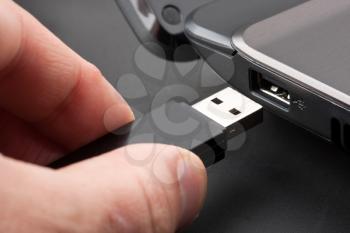 Plugging removable flash disk memory into laptop USB slot