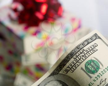 $100 dollar bill against gift box