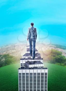 Businesswoman walking on the roof of high office buildings