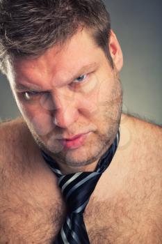 Angry shirtless man closeup studio shot