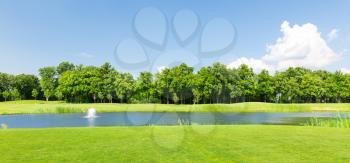 Panorama view of beautiful summer park with little pond