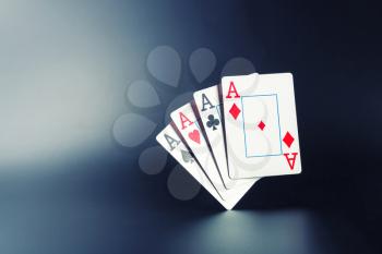 Four aces on dark background