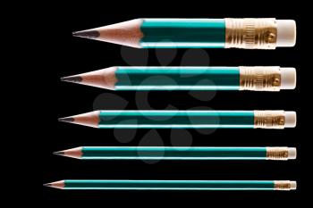 Five pencils on black background