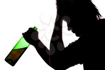 Silhouette of sad man drinking alcohol. Isolated on white