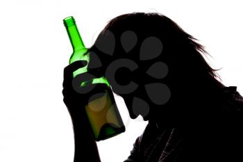 Silhouette of sad man drinking alcohol. Isolated on white