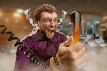 Angry bearded man screaming into the phone