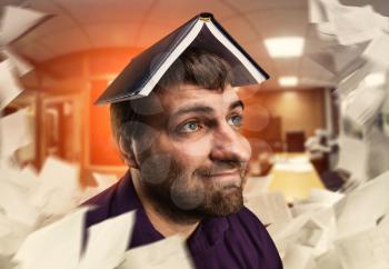 Adult bearded man with notebook on his head in the room