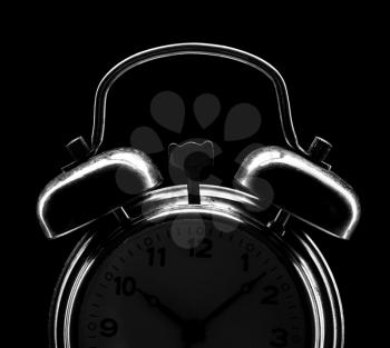 Silhouette of classical alarm clock isolated on black