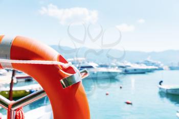 Lifebuoy in sea port against yachts at summer day