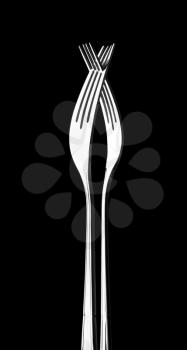 Two crossed silver forks. In B/W