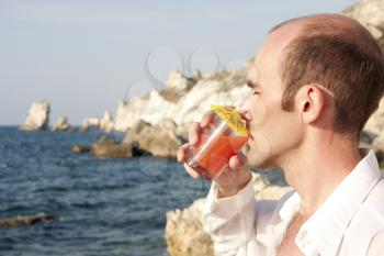 Man drinking cocktail on the beach
