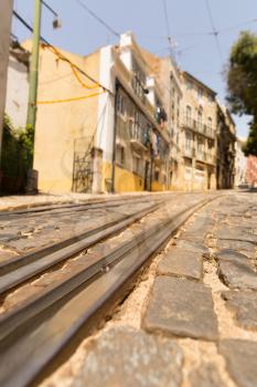 Tram lines on paved road on the narrow street closeup